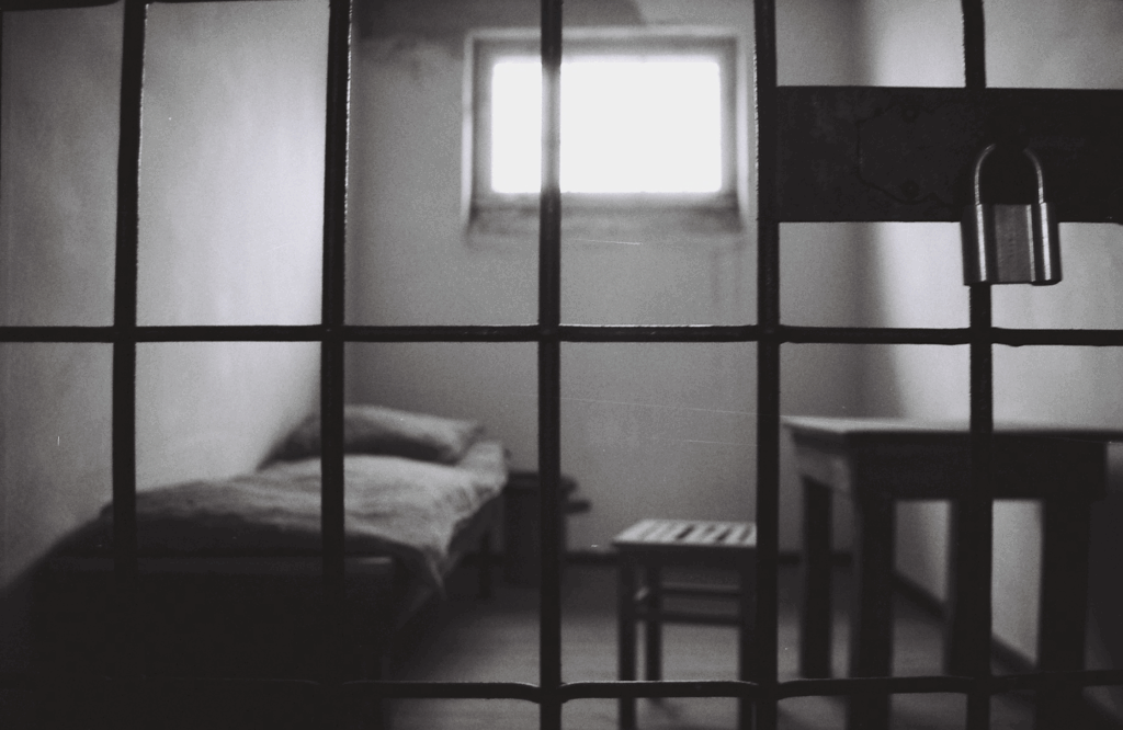 Black and white photo of a stark, overheated prison cell, showing the urgent need for humane climate control reforms in Texas correctional facilities.